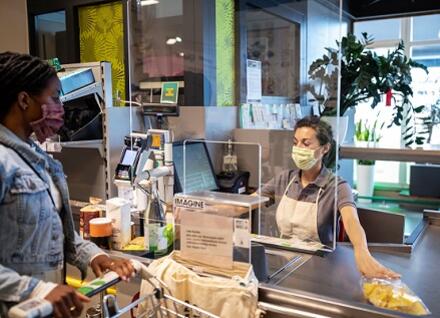 customer and cashier at grocery store check-out