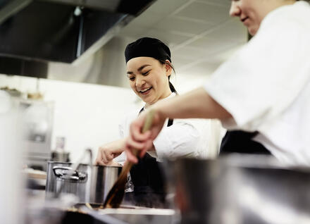 A cook in a restaurant kitchen