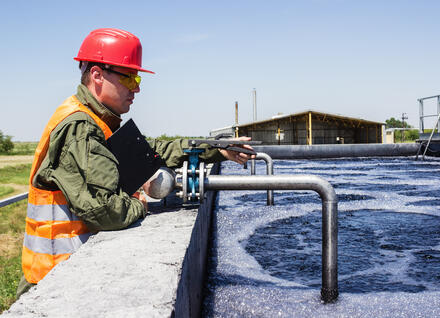worker checking public water system worker checking public water system