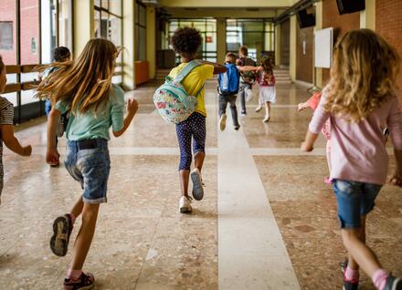 kids running down school hallway