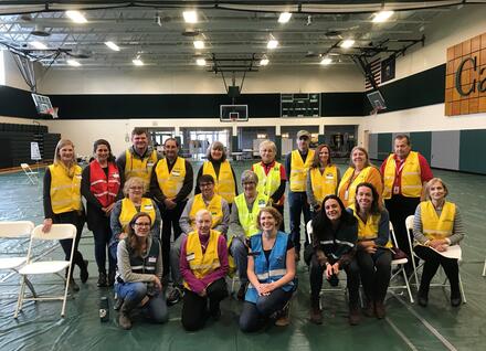 Staff and volunteers smiling at camera after completing a Point of Distribution exercise.