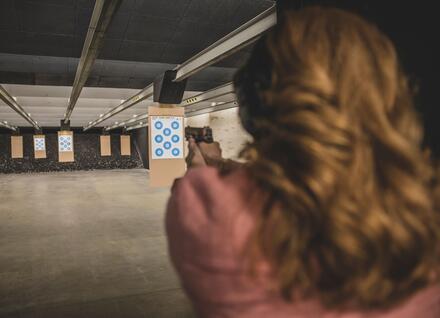 Women practicing shooting at shooting range.