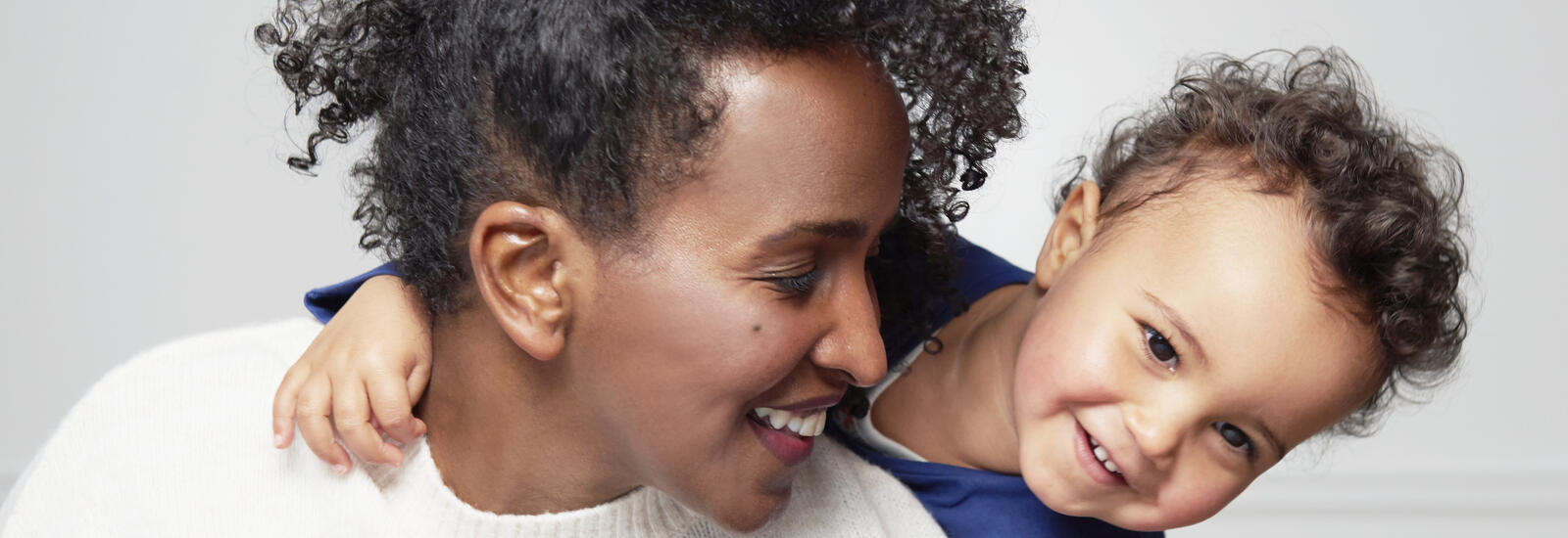 mom and toddler smiling
