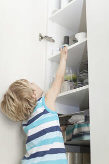 child reaching onto top shelf