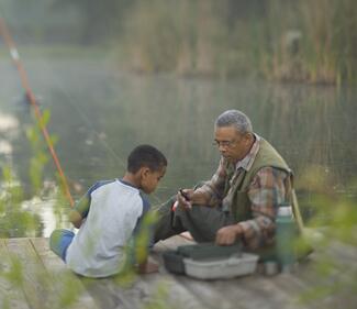 older man and boy fishing