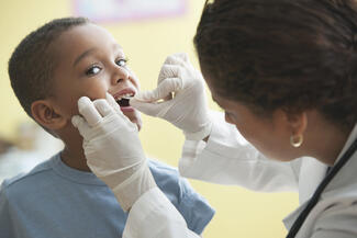 child having teeth examined