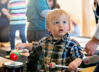 toddler playing drums