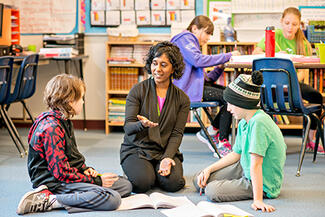 IGroup_7_educator_teacher_w_2student_floor_VT.jpg