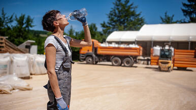 worker drinking water on hot day