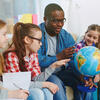 teacher with students and globe