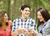 three young adults looking at phone