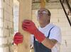 worker in gloves holding board