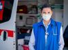 first responder in front of emergency vehicle