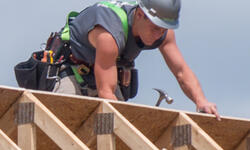 man building roof
