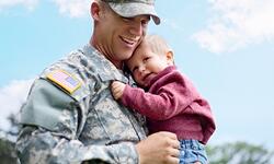 man in uniform holding baby