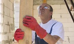 worker in gloves holding board