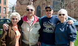 four people smiling