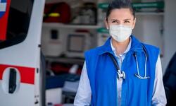 first responder in front of emergency vehicle